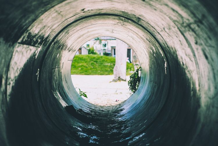 View along the inside of a large drain pipe