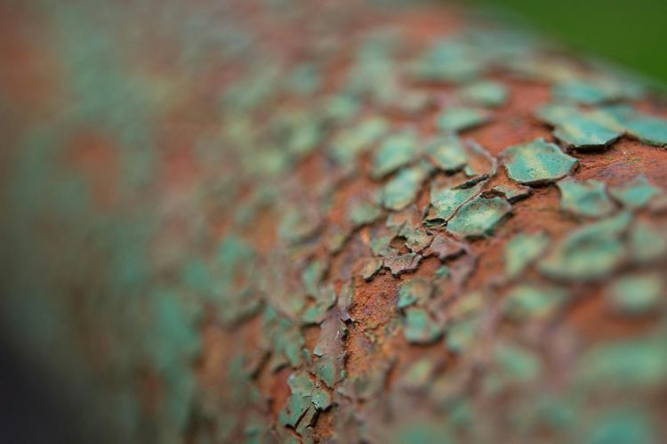 Green verdigris and rust on corroded metal