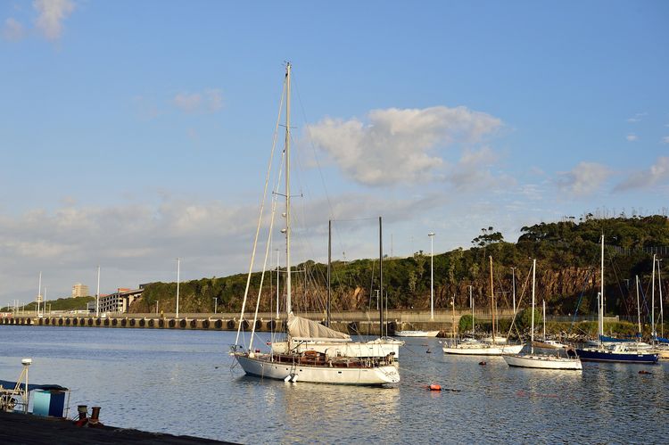 Yachts moored on the Buffalo River in East London, with the Buffalo Bridge behind