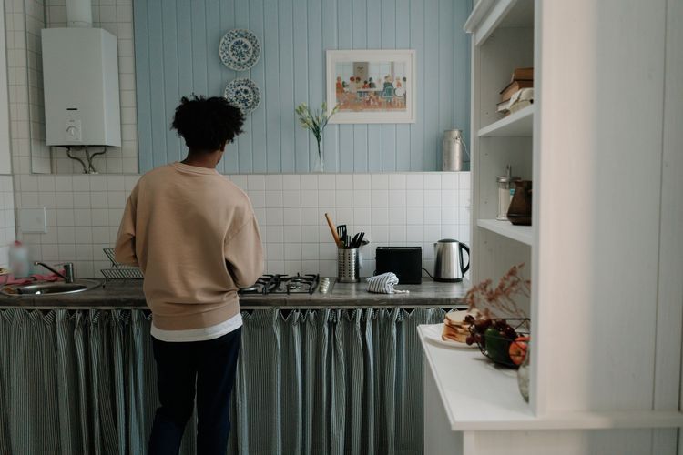 Wall-mounted gas water heater in a small kitchen